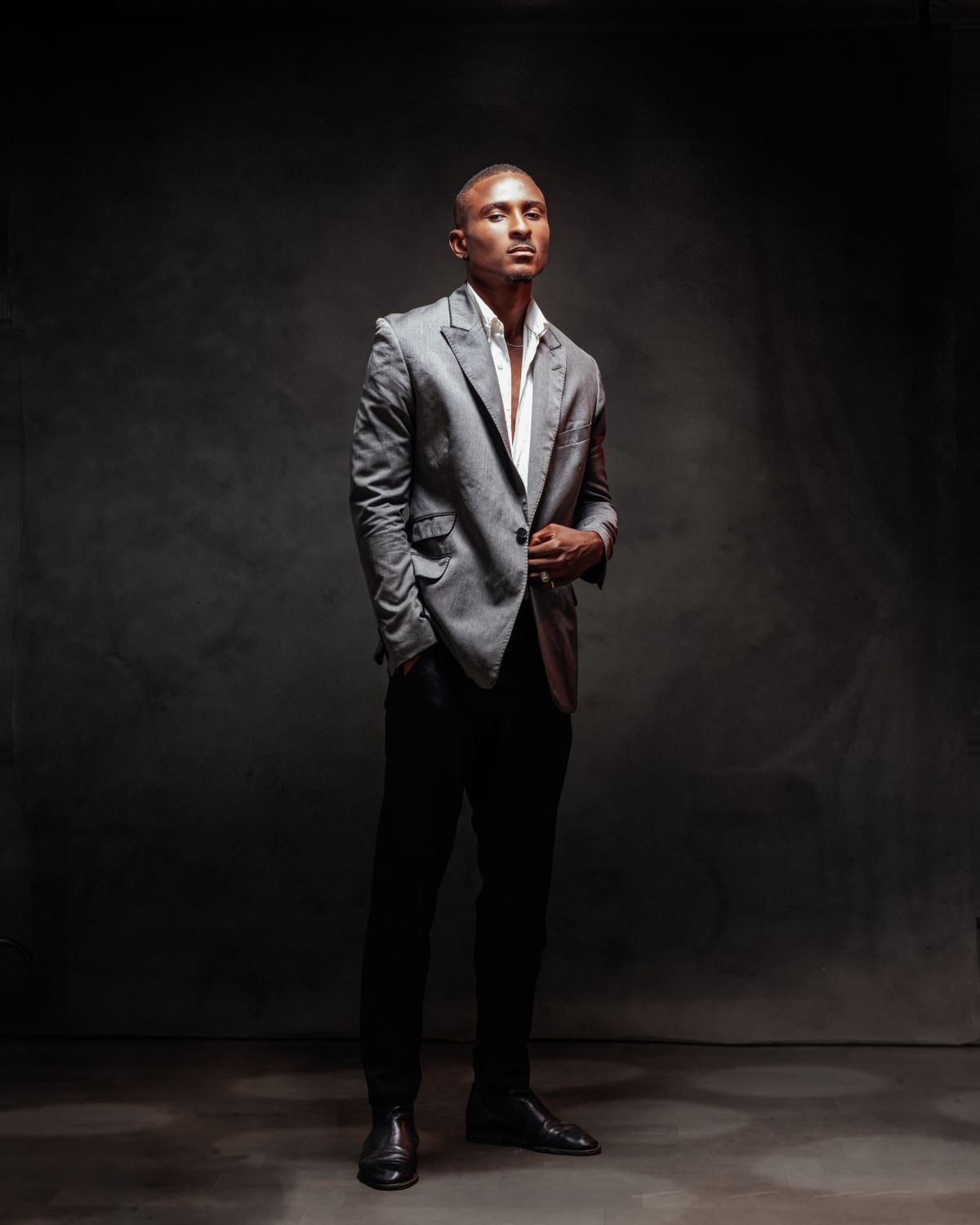 Full-length studio photograph of a man in a suit.