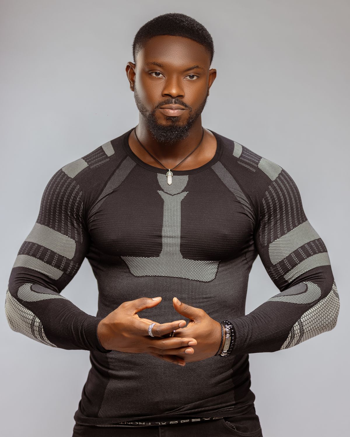 Man wearing a dark patterned performance top.