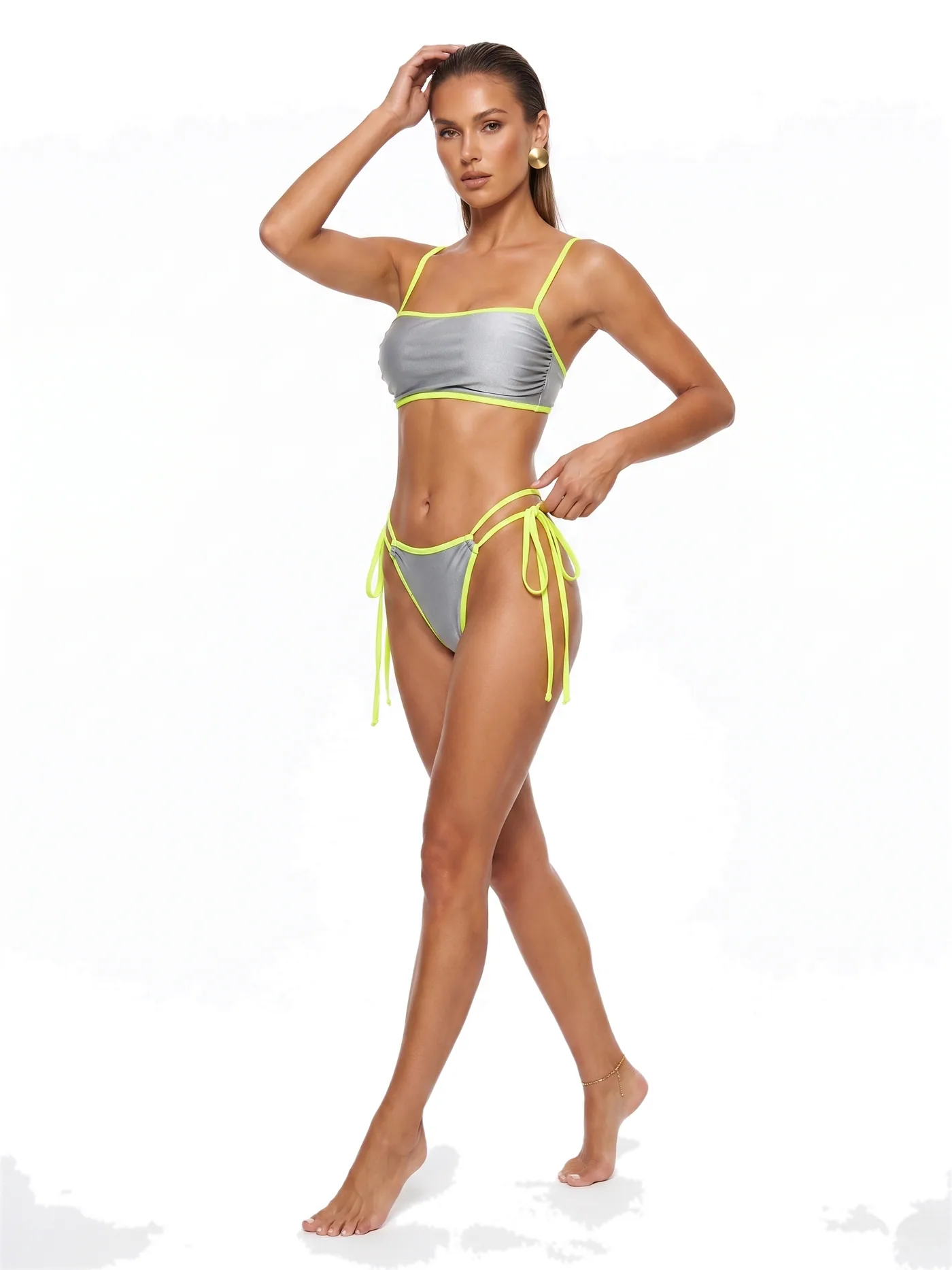 A bandeau bikini with contrast binding and long tie sides, photographed on a white studio ground.