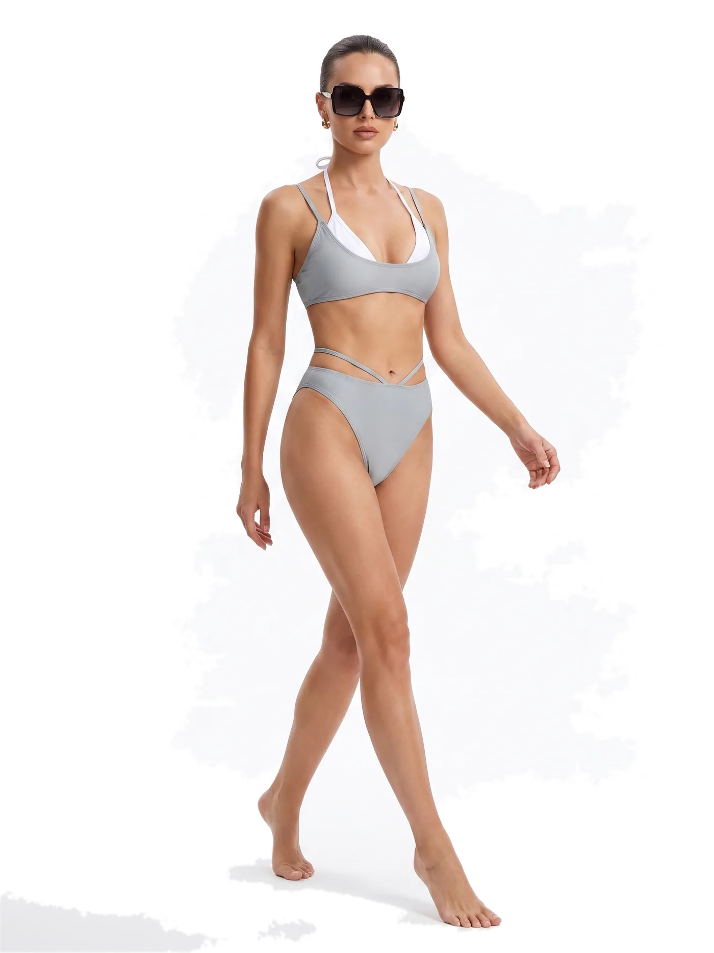 A silver halter bikini with high-cut briefs, photographed on a white studio ground.